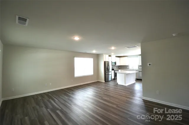 a view of a kitchen and wooden floor