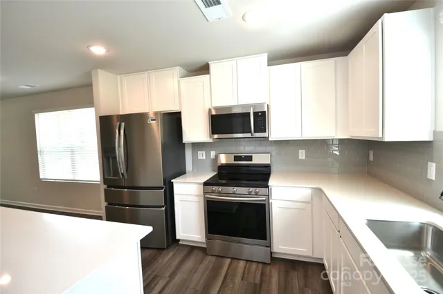 a kitchen with a refrigerator stove and microwave