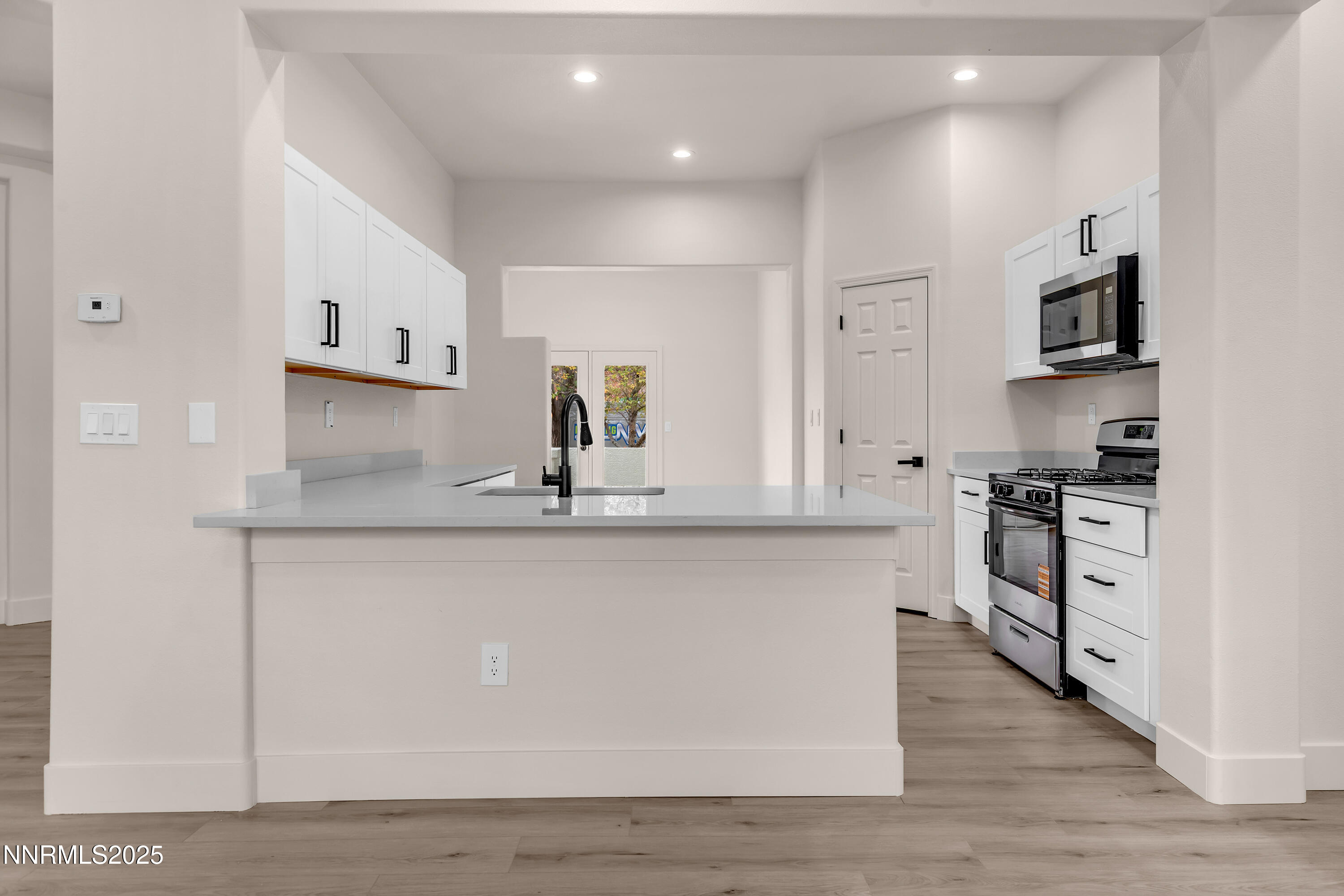 1651 Emerald Bay Drive Reno, NV 89521 - Photo 12 of 50 a kitchen with stainless steel appliances a sink stove and cabinets