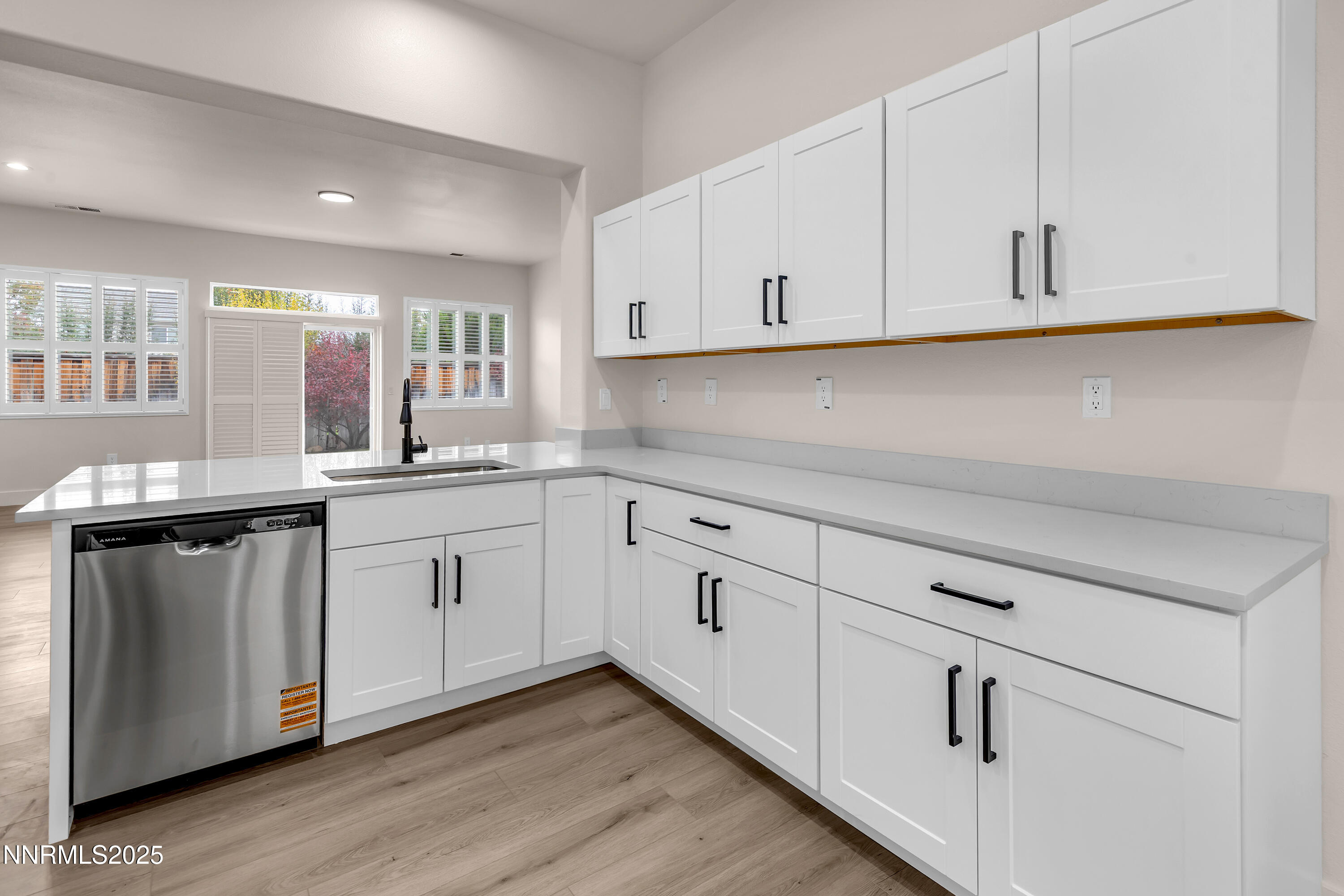 1651 Emerald Bay Drive Reno, NV 89521 - Photo 15 of 50 a kitchen with white cabinets white appliances sink and dishwasher