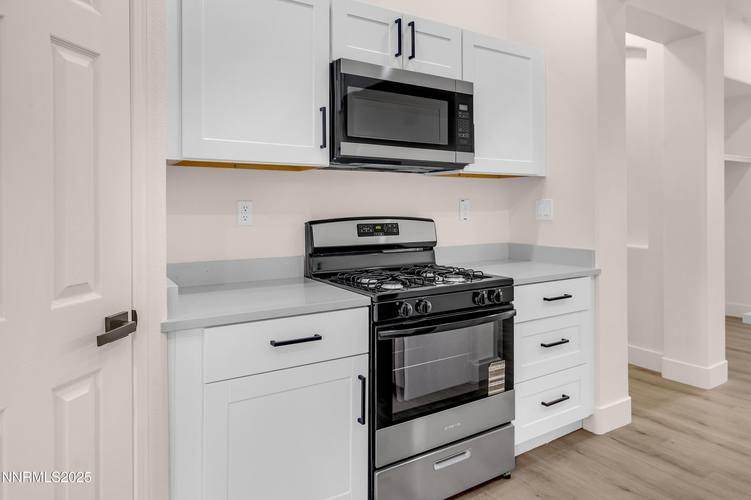 1651 Emerald Bay Drive Reno, NV 89521 - Photo 16 of 50 a kitchen with stainless steel appliances granite countertop white cabinets a microwave a stove and a microwave