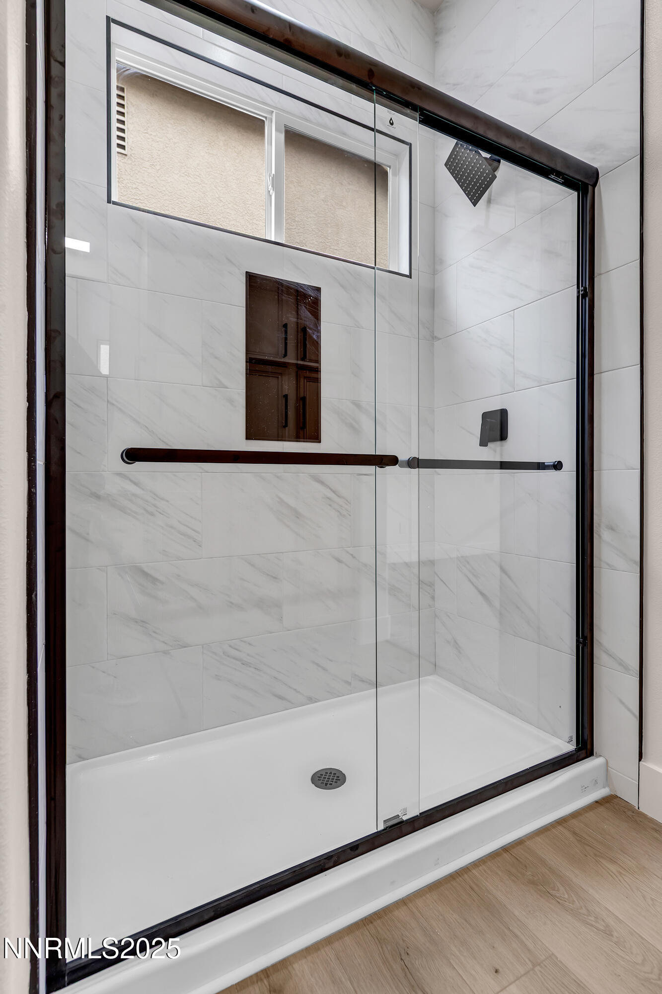 1651 Emerald Bay Drive Reno, NV 89521 - Photo 29 of 50 a bathroom with a glass shower door