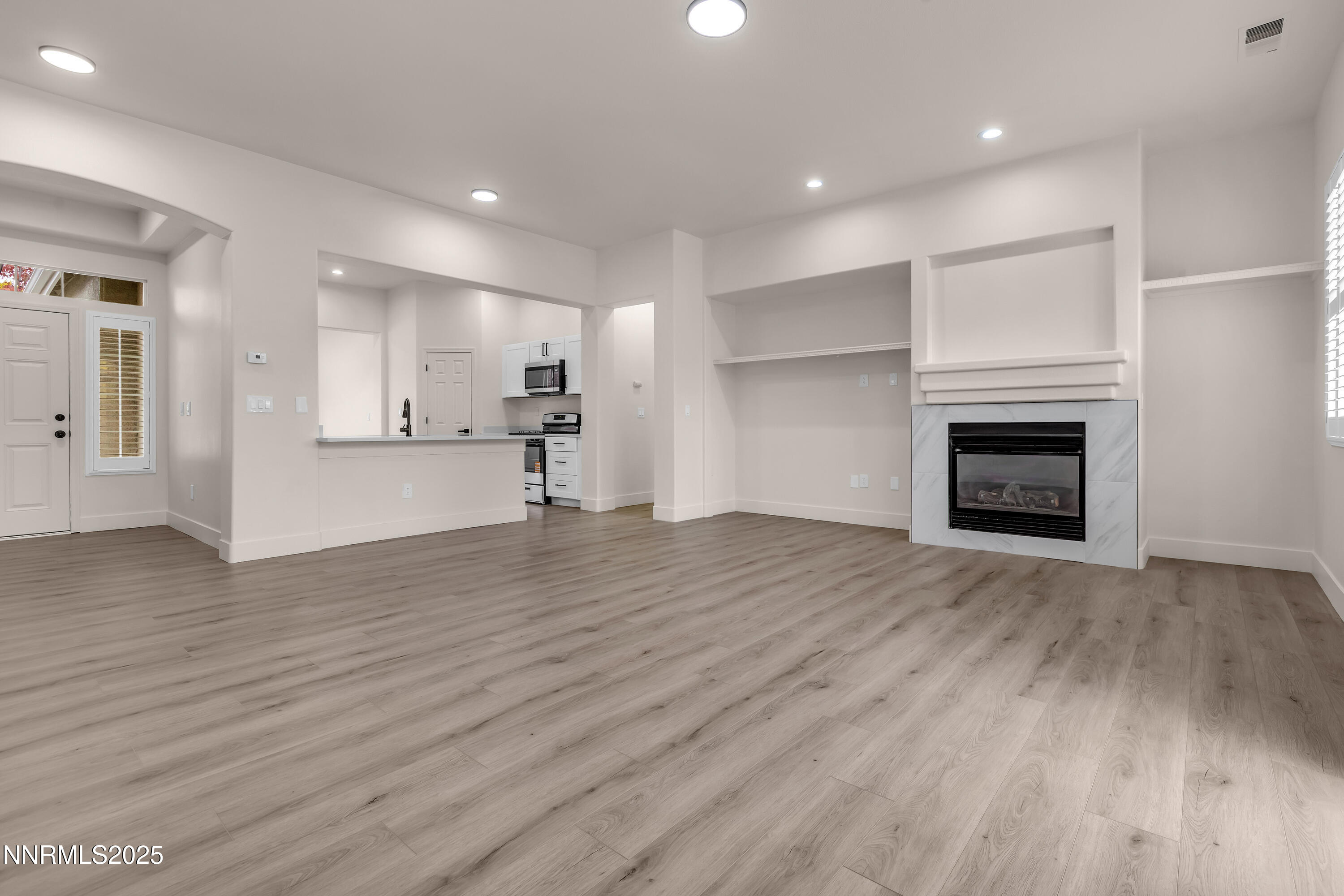 1651 Emerald Bay Drive Reno, NV 89521 - Photo 7 of 50 a view of empty room with wooden floor and fireplace