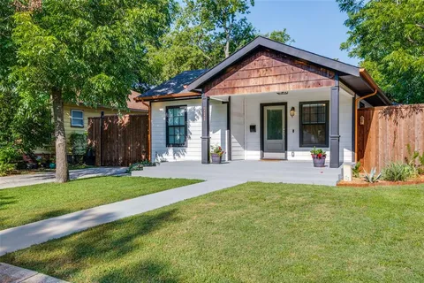 a front view of a house with a yard and porch