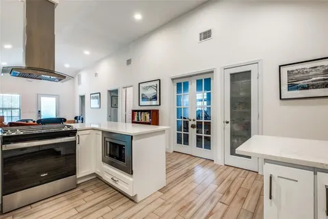 a kitchen with stainless steel appliances a stove top oven and sink