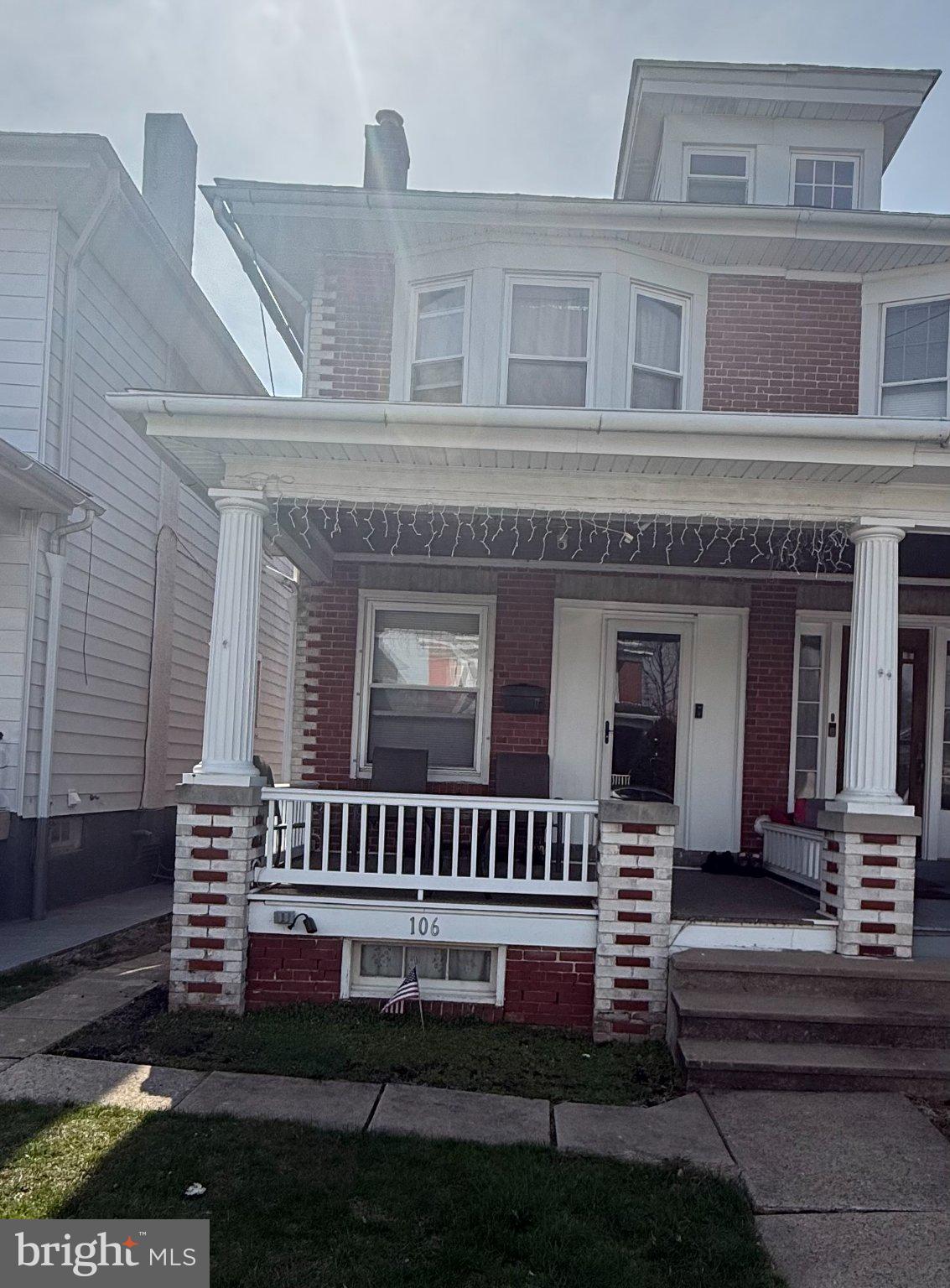 Charming brick duplex with porch appeal.