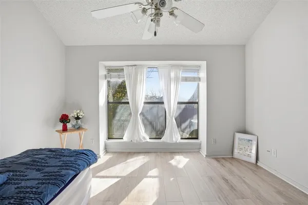a living room with a couch and wooden floor
