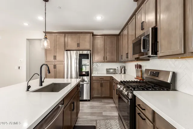 a kitchen with refrigerator cabinets and a sink