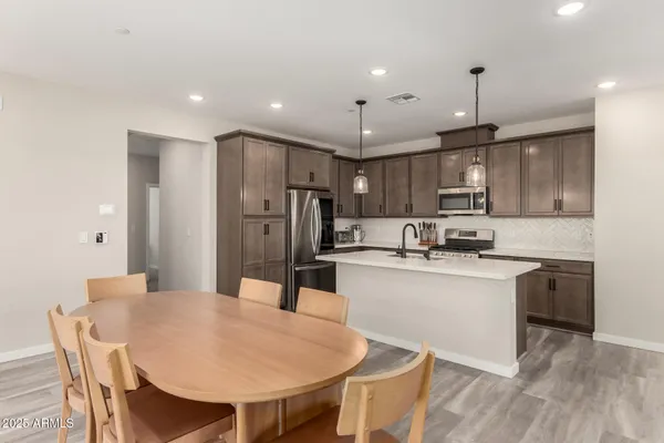 a large kitchen with a table and chairs