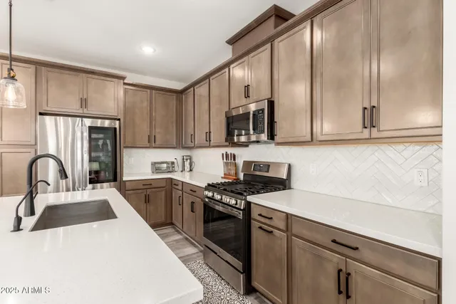 a kitchen with stainless steel appliances granite countertop a stove a sink dishwasher and a microwave