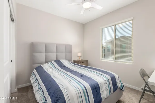 a bedroom with a bed and a table