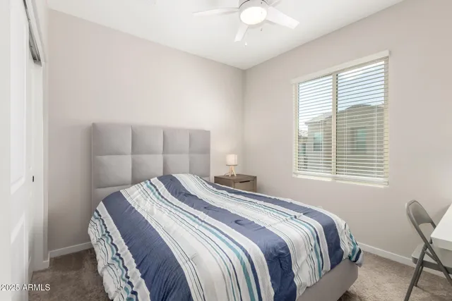 a bedroom with a bed and a table