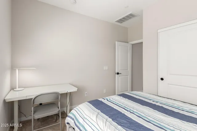 a bedroom with a bed and a window