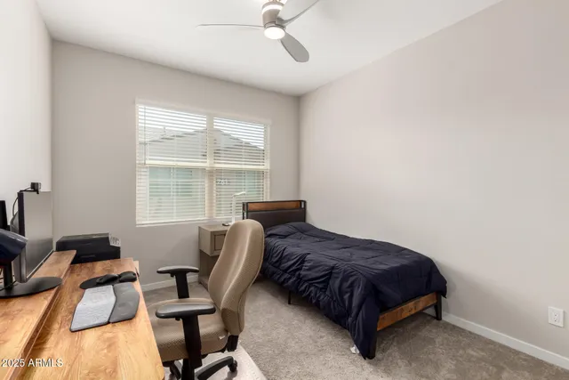 a bedroom with a bed and a chair