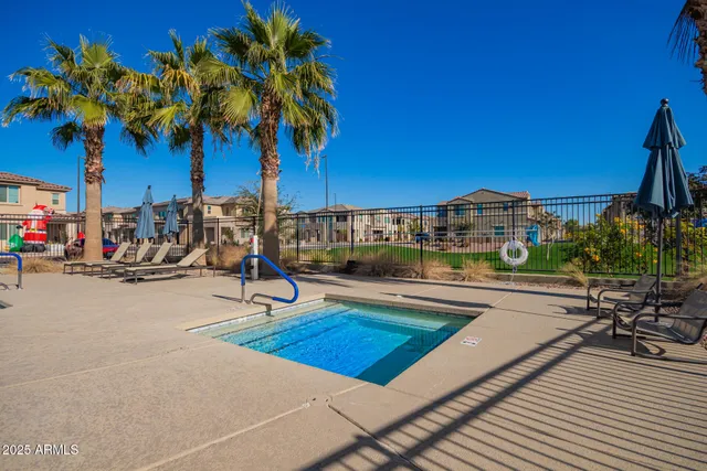 a view of a swimming pool with a table and chairs