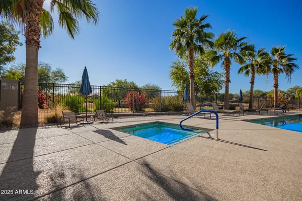 a view of a swimming pool with a chair and tables
