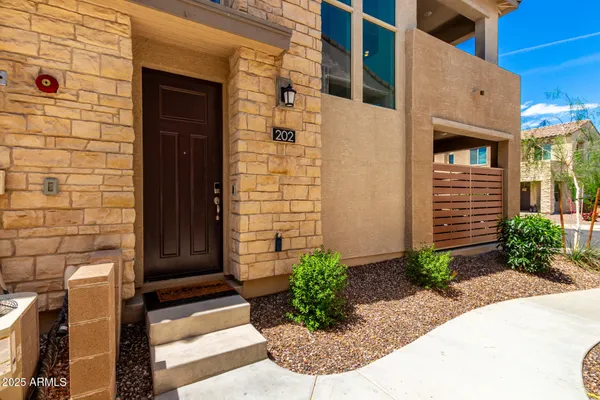 a view of a brick house with potted plants