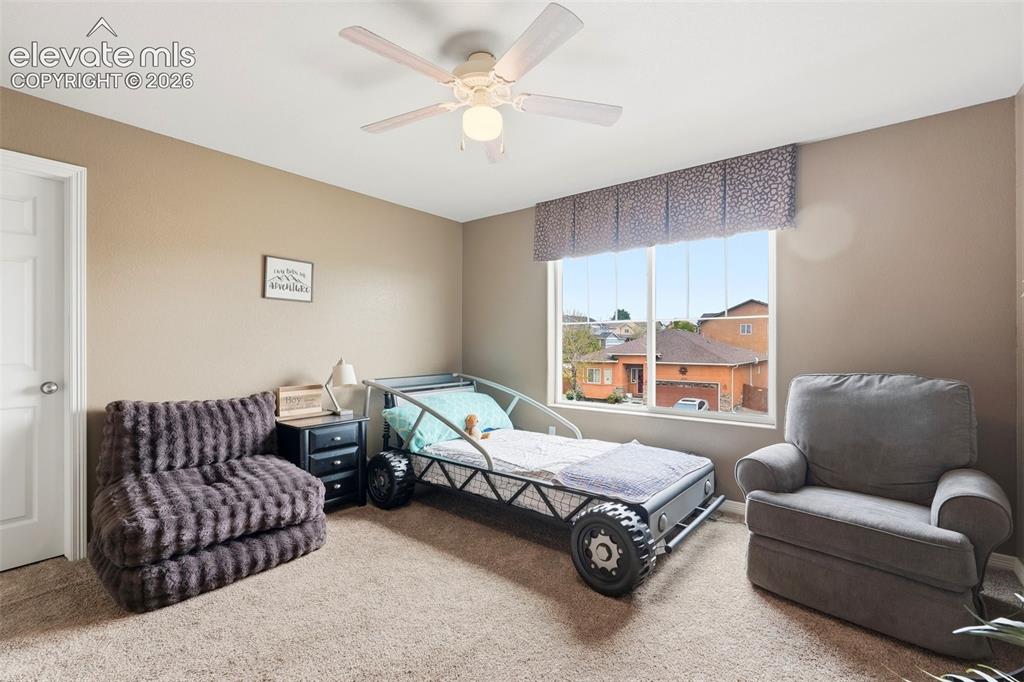 2264 Reed Grass Way Colorado Springs, CO 80915 - Photo 25 of 50 a bedroom with furniture and a couch