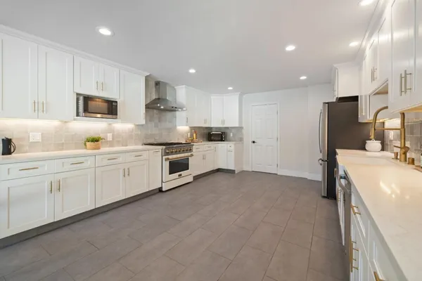 a bedroom with a bed and large windows