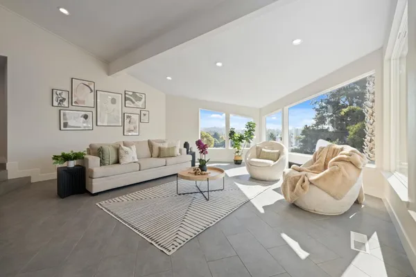 a living room with furniture kitchen and a table