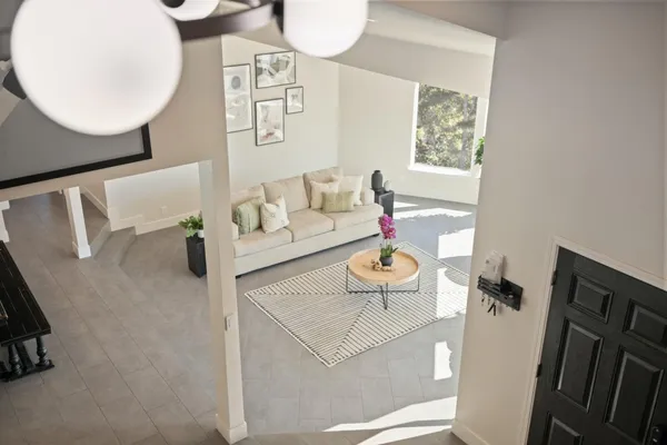 a spacious bedroom with a bed a table and large window