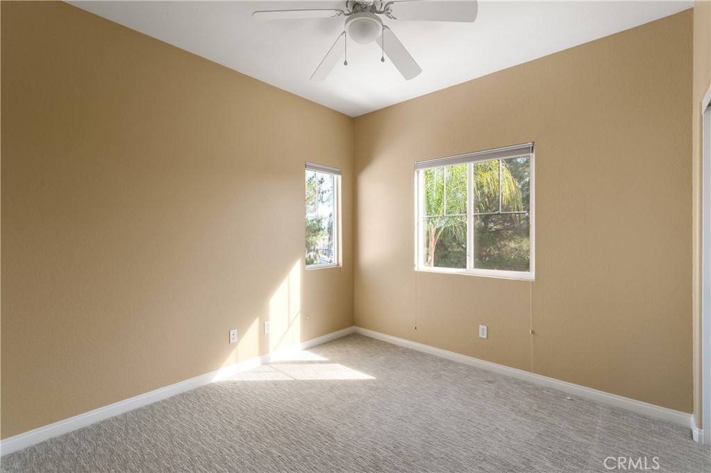 28817 Edenton Way Temecula, CA 92591 - Photo 38 of 56 an empty room with a window and a ceiling fan