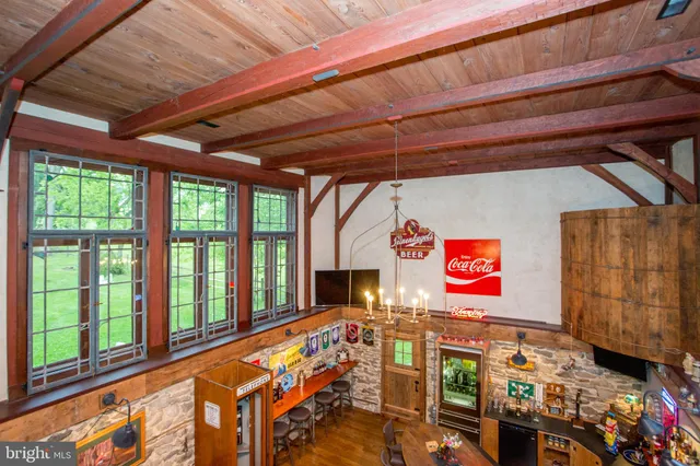 a view of a patio with table and chairs under an umbrella