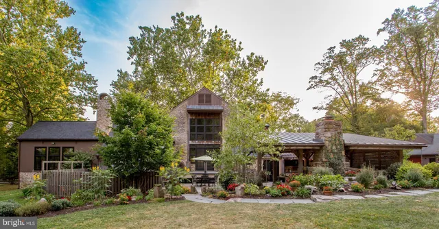 a view of a house with garden and sitting area