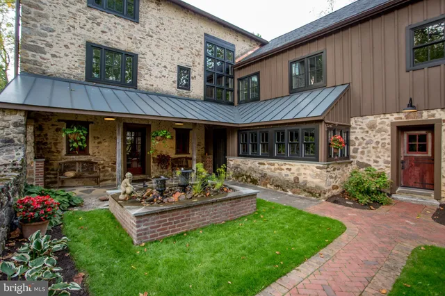 a view of a hallway with dining room and wooden floor