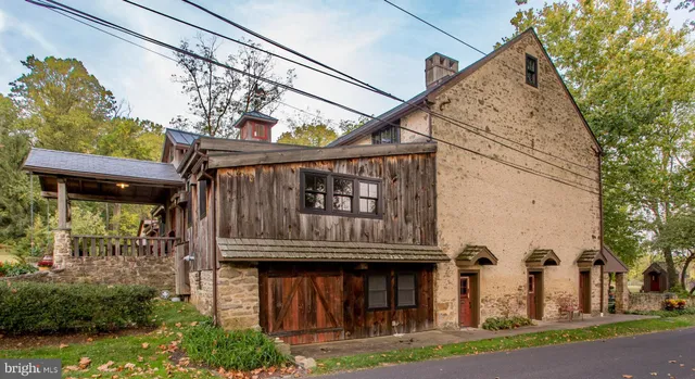 a living room with furniture a fireplace and a floor to ceiling window