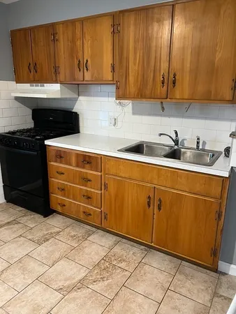 a kitchen with stainless steel appliances a stove a sink and a microwave