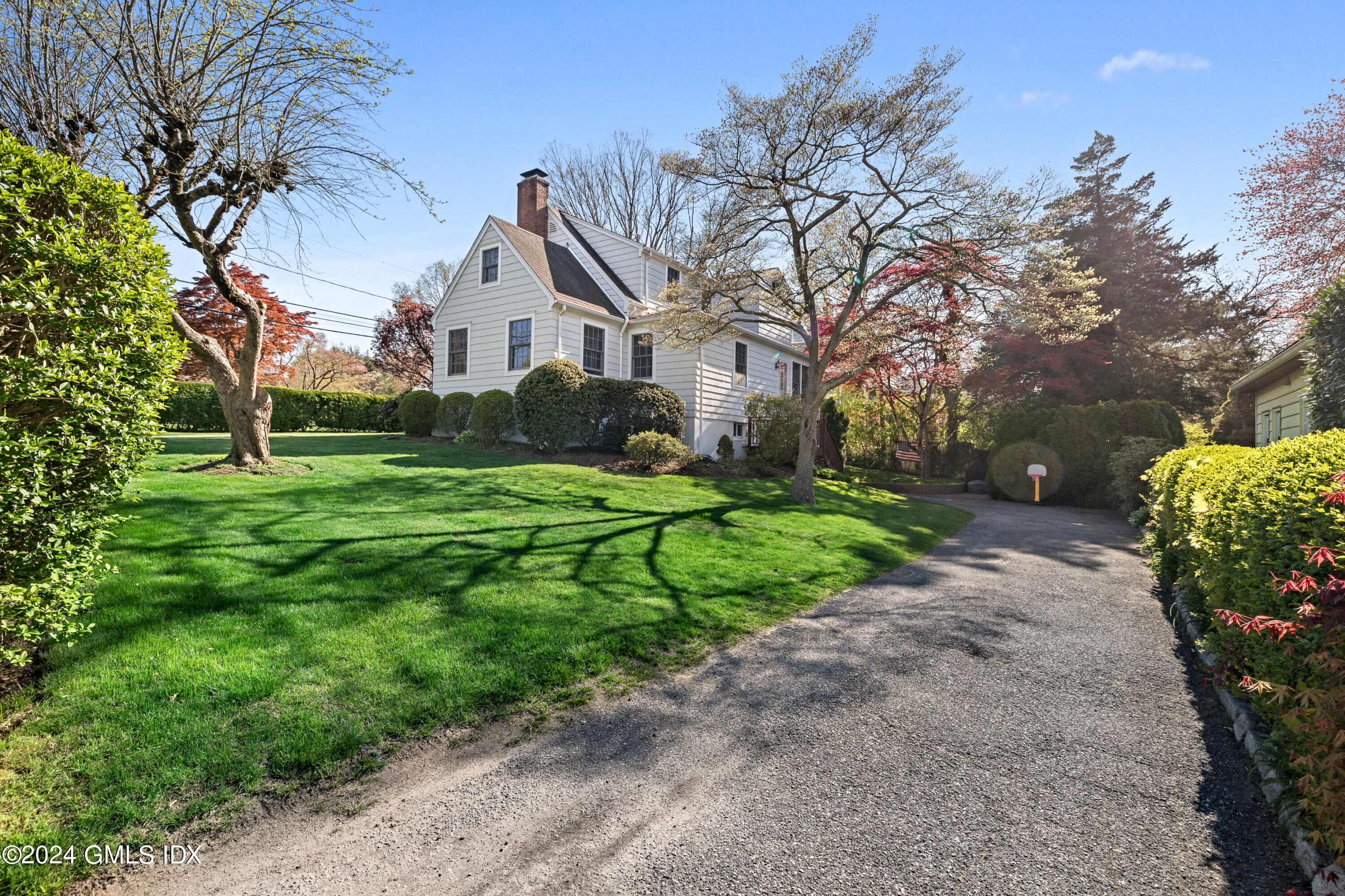29 Park Place Darien, CT 06820 - Photo 3 of 22 a front view of a house with yard and green space