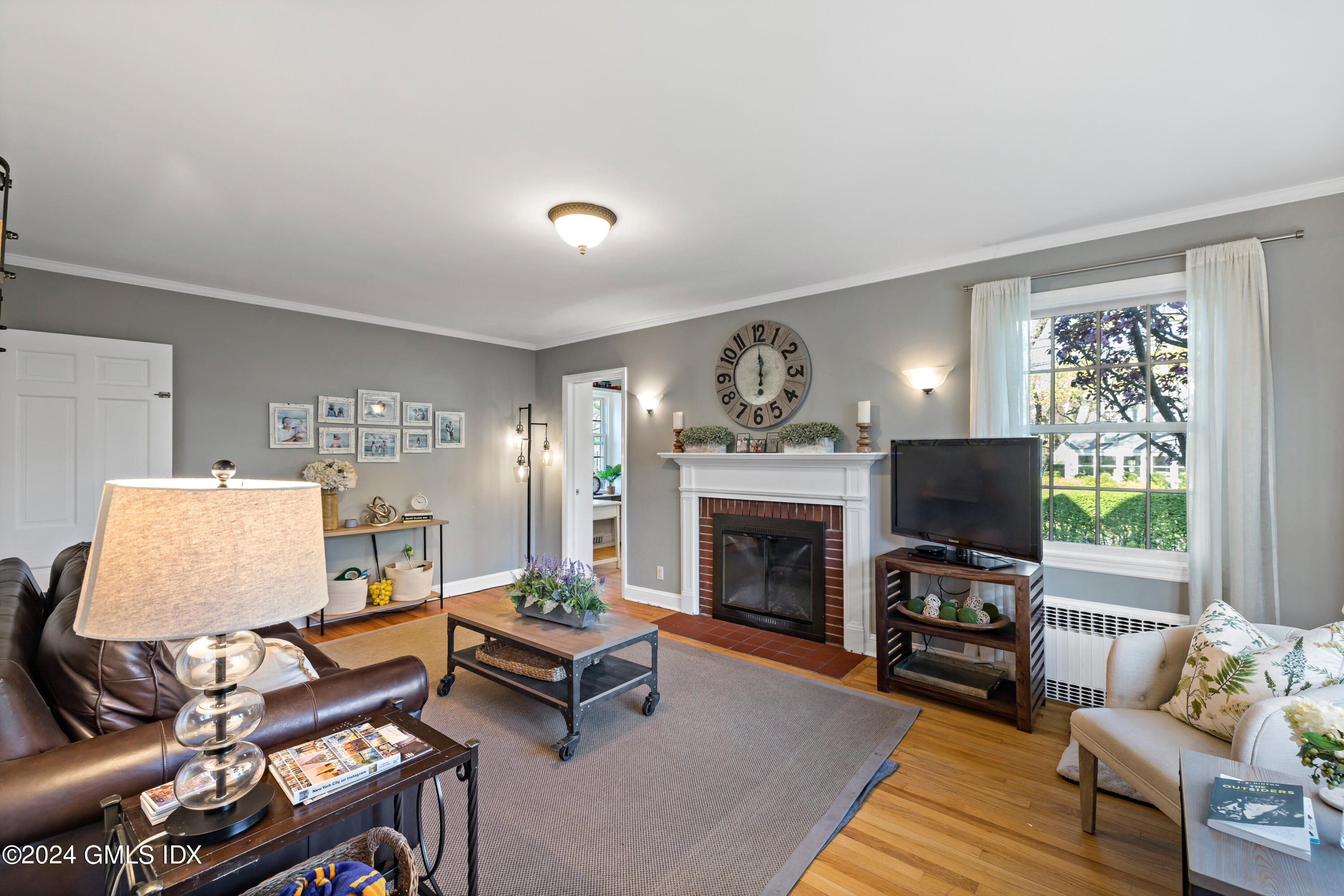 29 Park Place Darien, CT 06820 - Photo 8 of 22 a living room with furniture a flat screen tv and a fireplace
