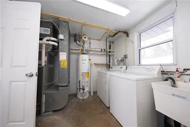 a utility room with cabinets washer and dryer