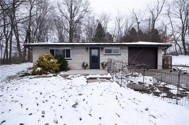 a view of house with yard and sitting area