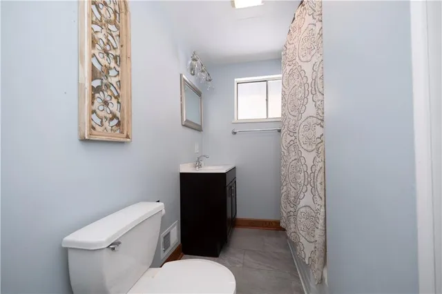 a white toilet sitting next to a bathroom sink