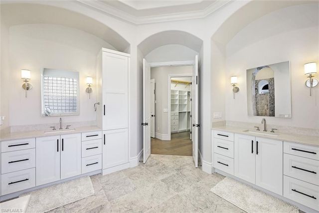 a spacious bathroom with a granite countertop sink mirror and a
