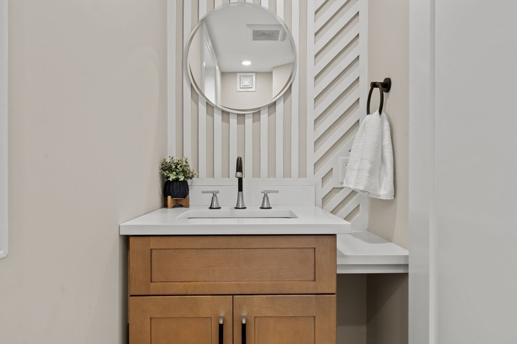 162 High Street, Unit B Danvers, MA 01923 - Photo 12 of 32 a bathroom with a sink and a mirror