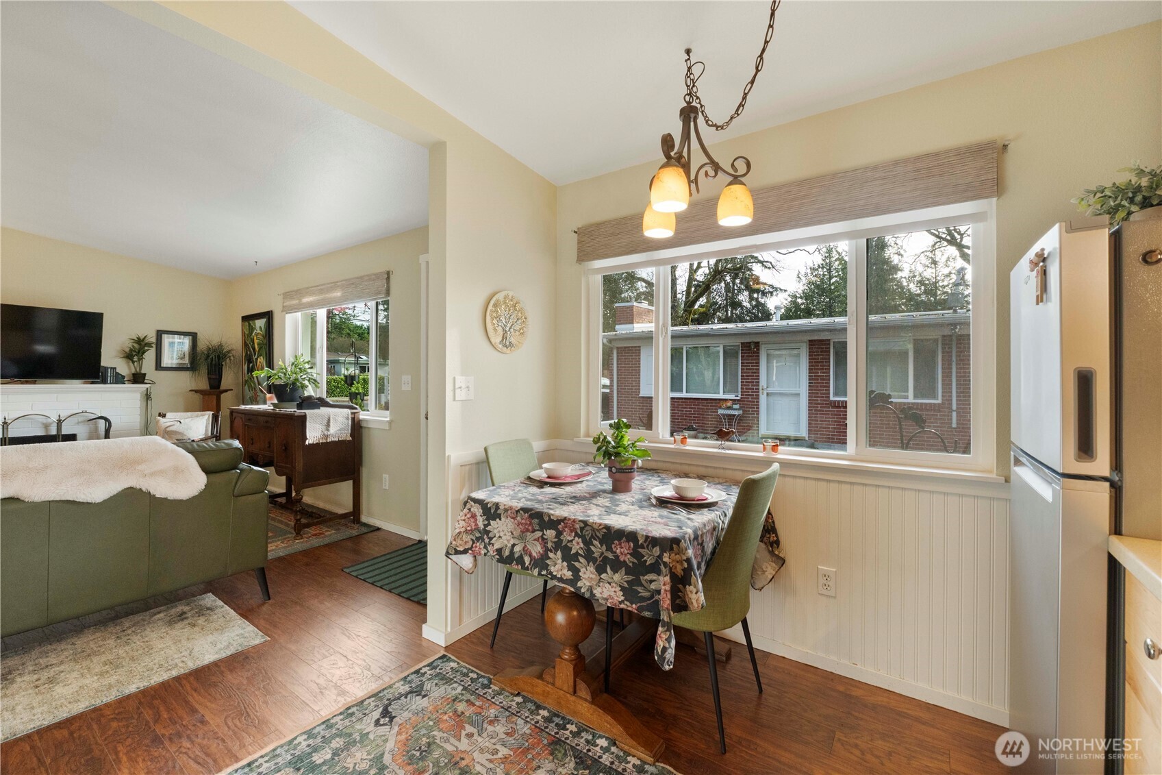 8414 John Dower Road Southwest, Unit 14 Lakewood, WA 98499 - Photo 11 of 33 a living room with furniture a chandelier and a dining table