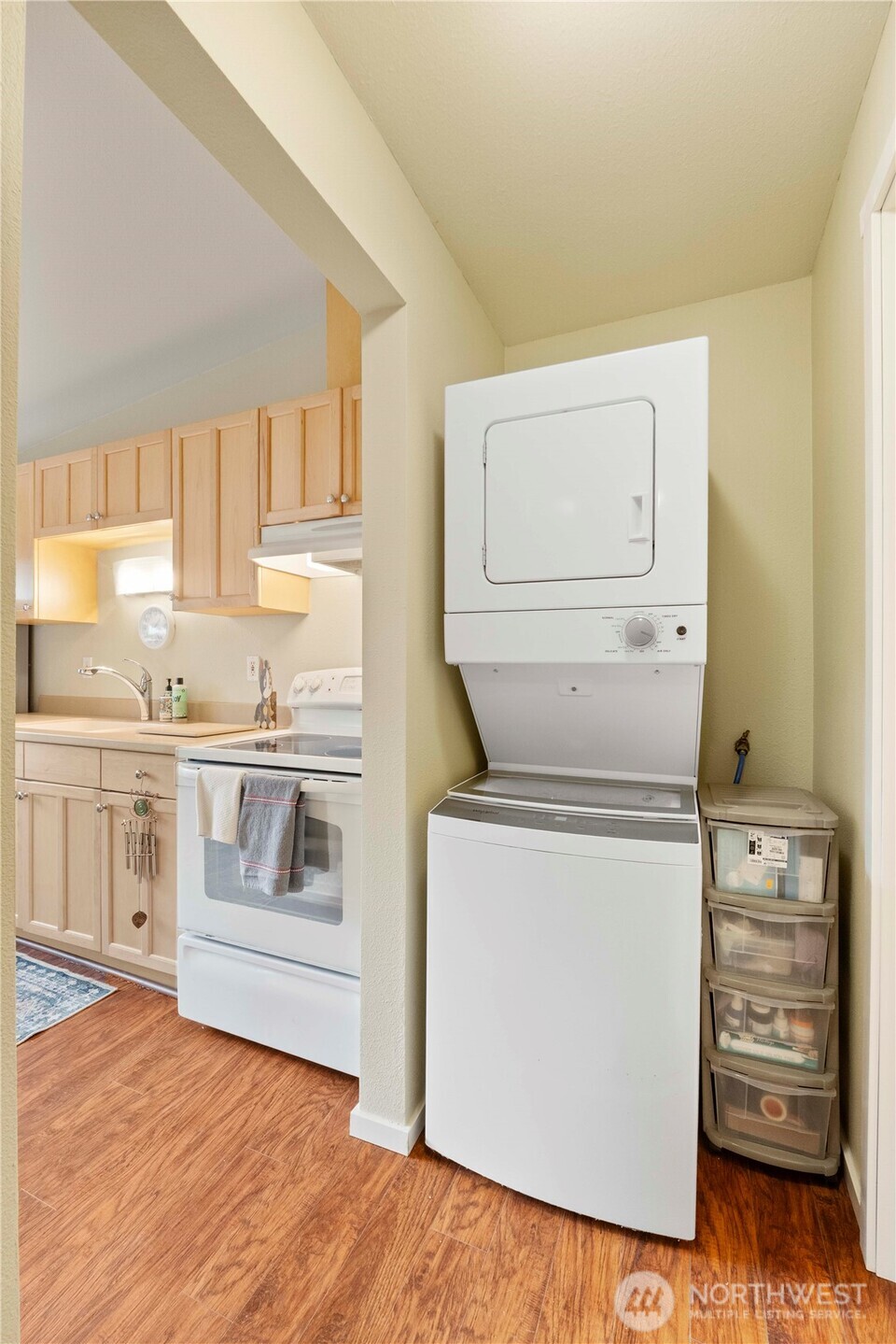 8414 John Dower Road Southwest, Unit 14 Lakewood, WA 98499 - Photo 13 of 33 a kitchen with stove cabinets and wooden floor