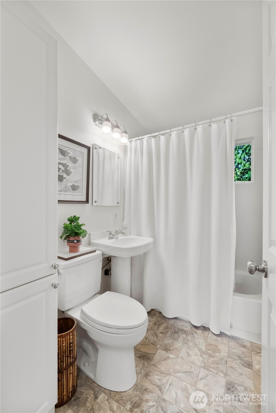 8414 John Dower Road Southwest, Unit 14 Lakewood, WA 98499 - Photo 15 of 33 a white toilet sitting next to a bathroom sink and a shower