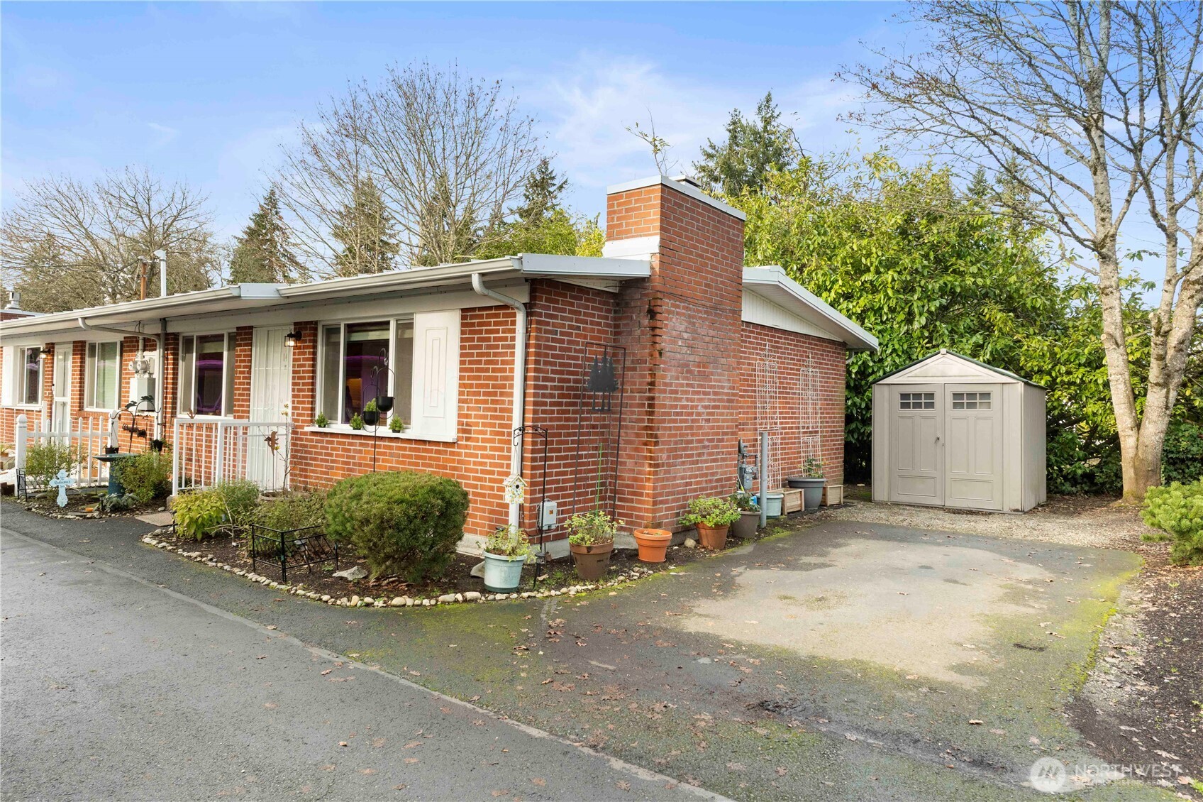 8414 John Dower Road Southwest, Unit 14 Lakewood, WA 98499 - Photo 26 of 33 a front view of a house with a yard and garage