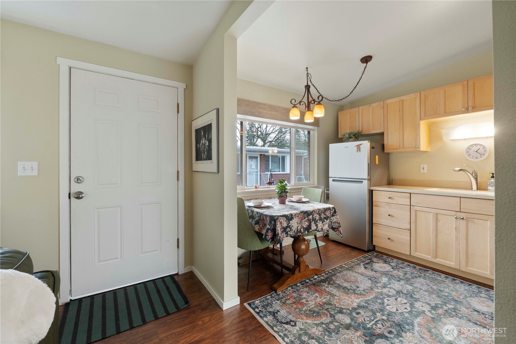 8414 John Dower Road Southwest, Unit 14 Lakewood, WA 98499 - Photo 8 of 33 a view of kitchen with sink refrigerator dining table and chairs