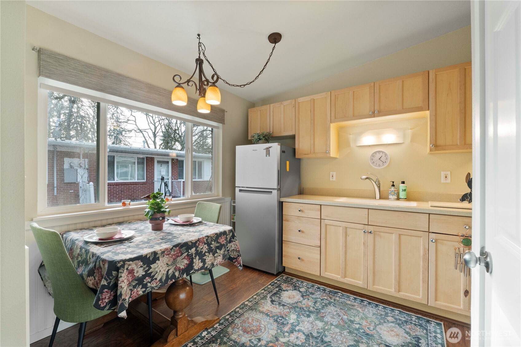 8414 John Dower Road Southwest, Unit 14 Lakewood, WA 98499 - Photo 9 of 33 a kitchen with a table chairs stove and refrigerator