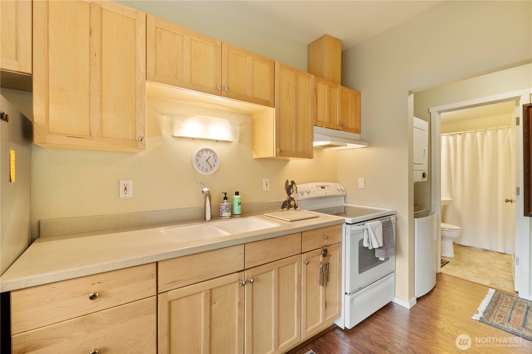 8414 John Dower Road Southwest, Unit 14 Lakewood, WA 98499 - Photo 10 of 33 a kitchen with a sink cabinets and wooden floor