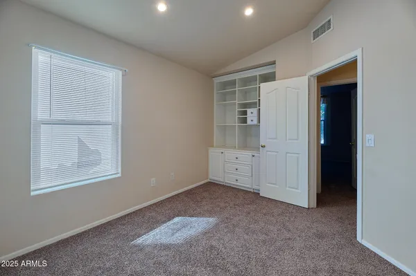 an empty room with windows and closet