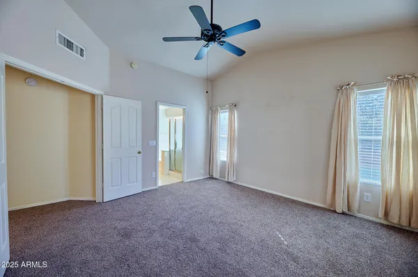 a view of an empty room with a ceiling fan