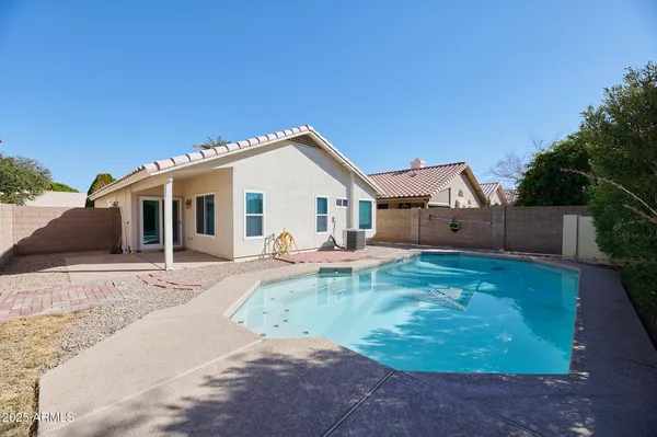a view of a house with backyard and sitting area