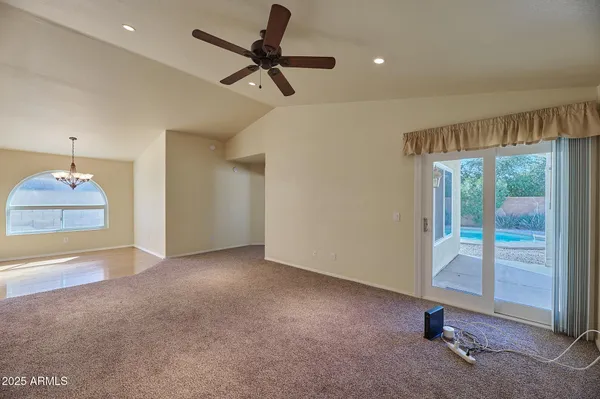 a view of a livingroom with a ceiling fan and window