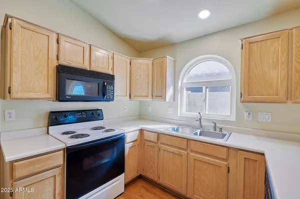 a kitchen with a sink stove and microwave